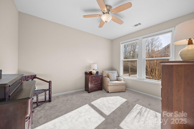 living area with ceiling fan and light carpet