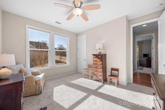 sitting room with light carpet and ceiling fan