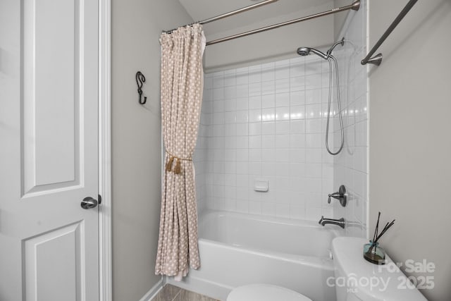 bathroom featuring shower / tub combo and toilet