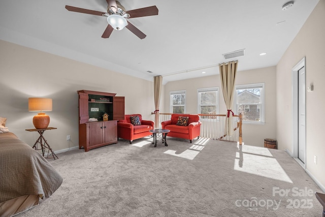 carpeted living room with ceiling fan