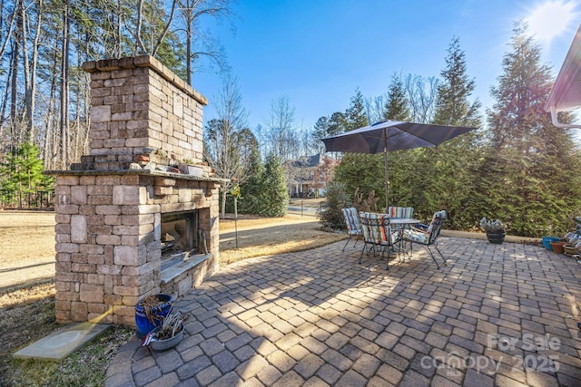 view of patio / terrace with an outdoor stone fireplace