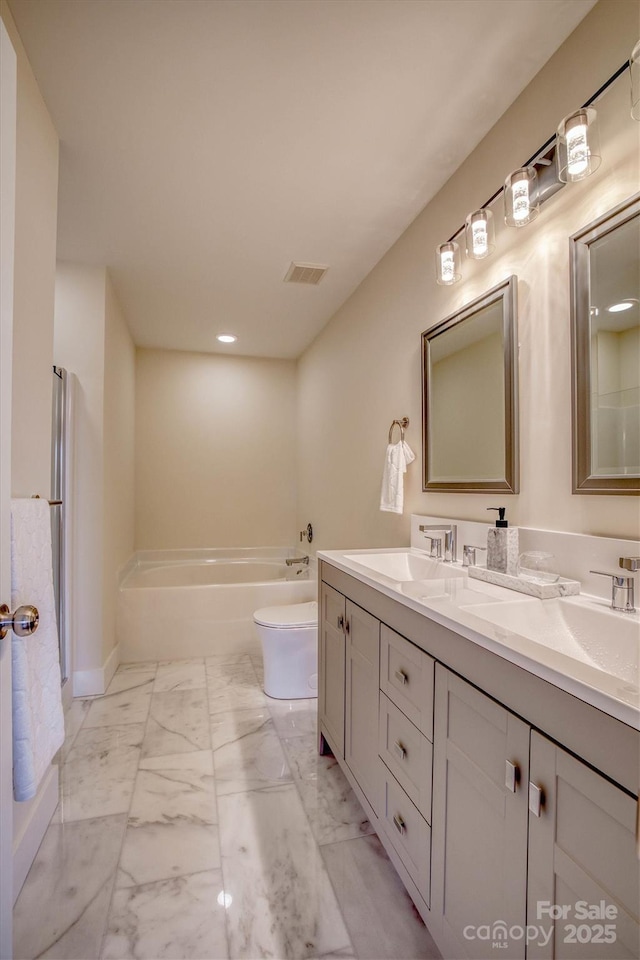 bathroom with vanity and toilet