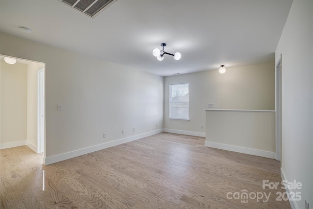 spare room with light wood-type flooring