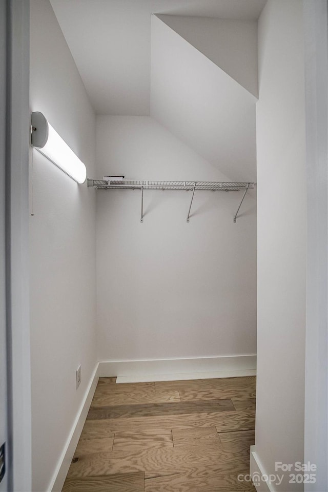 spacious closet featuring hardwood / wood-style floors