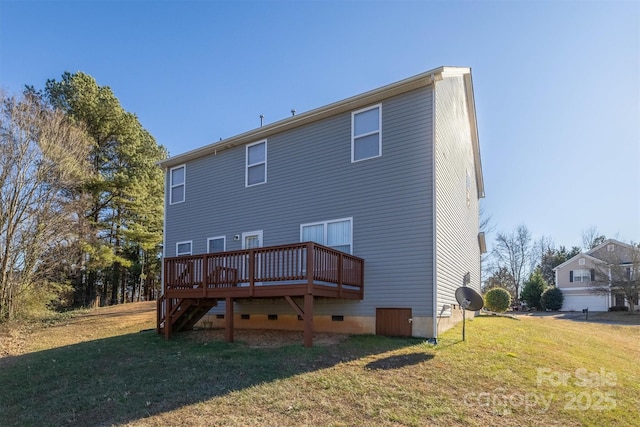 rear view of house with a lawn and a wooden deck