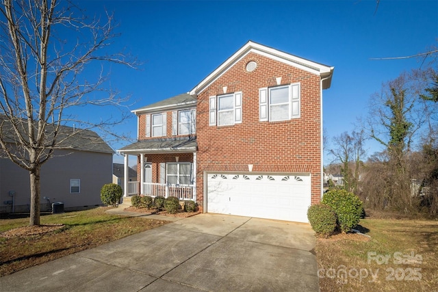 view of property with a porch and a garage