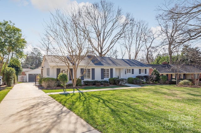 single story home with a front yard and a garage