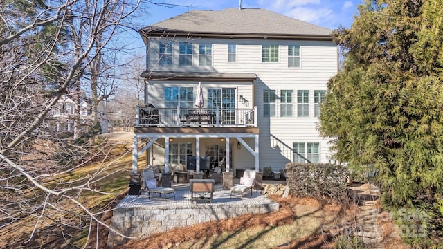 back of property with an outdoor hangout area and a patio area