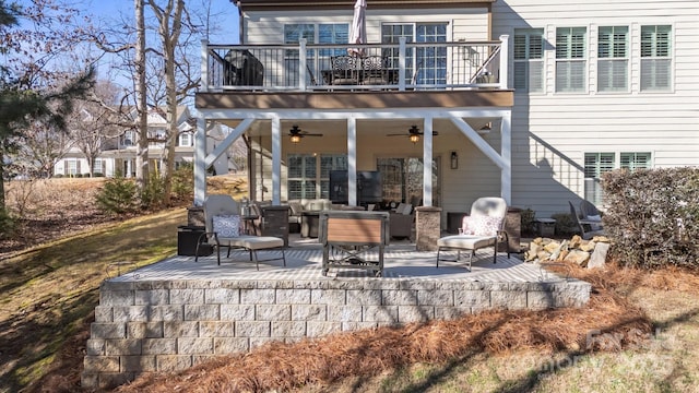 back of house with a patio area, ceiling fan, and a balcony