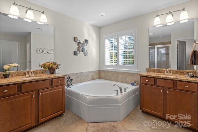 bathroom featuring tile patterned flooring, vanity, and plus walk in shower