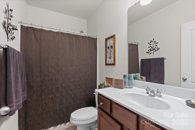 bathroom featuring walk in shower, vanity, and toilet