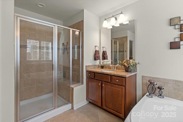 bathroom featuring tile patterned flooring, vanity, and a shower with shower door