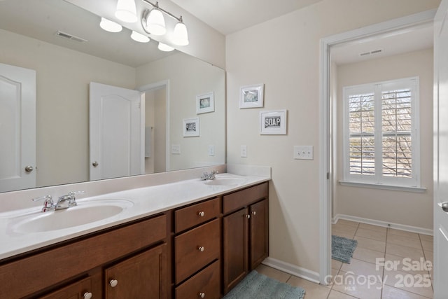 bathroom featuring tile patterned flooring and vanity