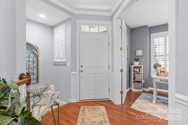 foyer entrance with hardwood / wood-style floors and ornamental molding