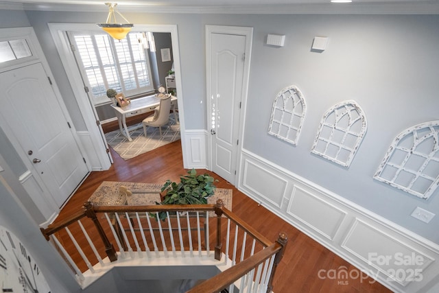 entrance foyer featuring crown molding and wood-type flooring