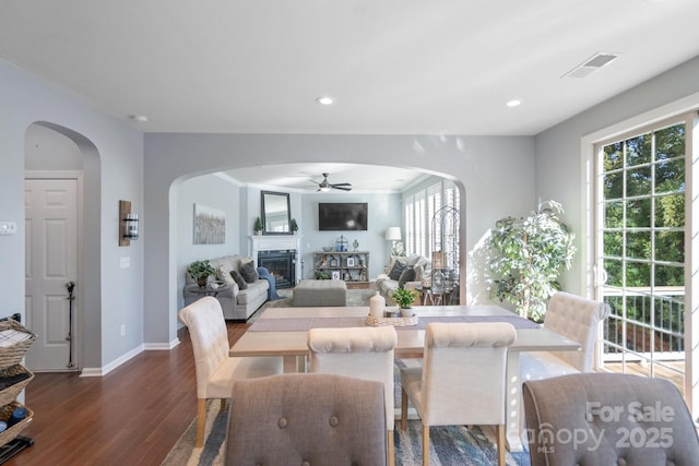 dining area with ceiling fan and dark wood-type flooring