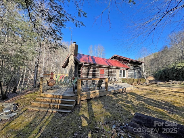 back of property featuring a wooden deck