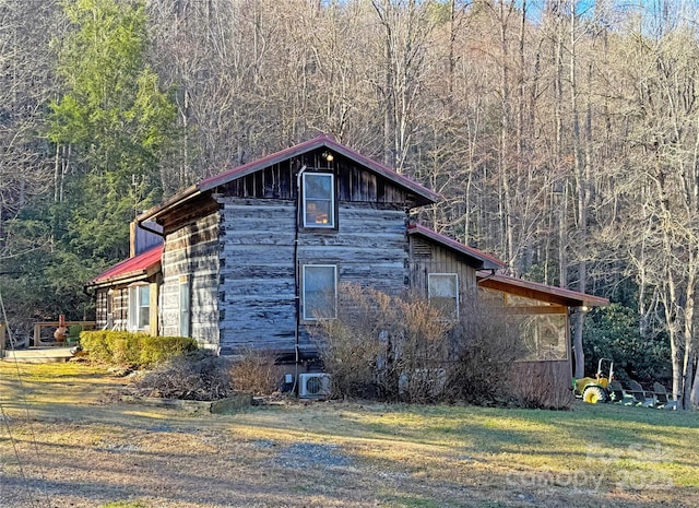 view of side of home with a lawn