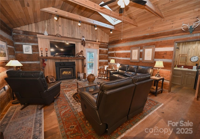 living room with a skylight, wood ceiling, ceiling fan, log walls, and beamed ceiling