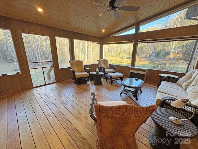 sunroom with plenty of natural light, vaulted ceiling, ceiling fan, and wooden ceiling