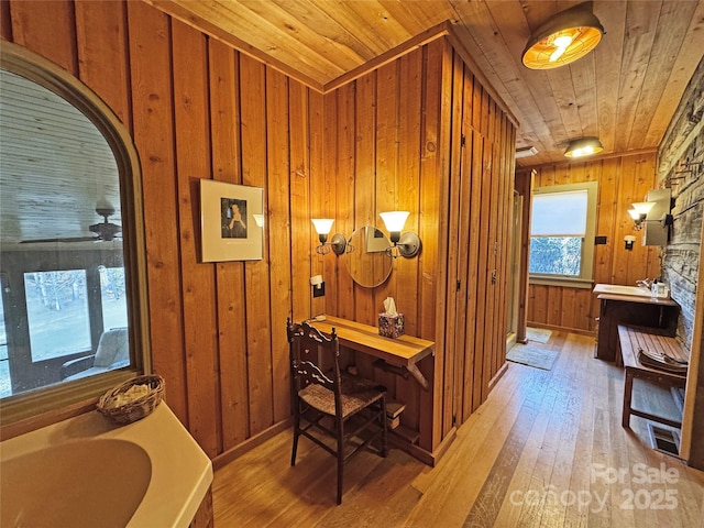 bathroom featuring a bathing tub, wood walls, hardwood / wood-style floors, vanity, and wood ceiling