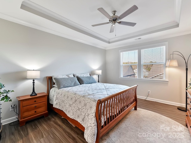 bedroom featuring ceiling fan, ornamental molding, a raised ceiling, and dark hardwood / wood-style floors