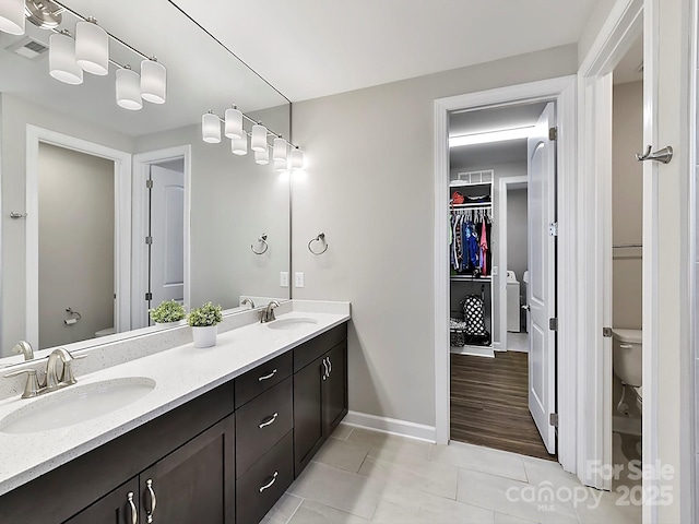 bathroom featuring tile patterned floors, vanity, and toilet