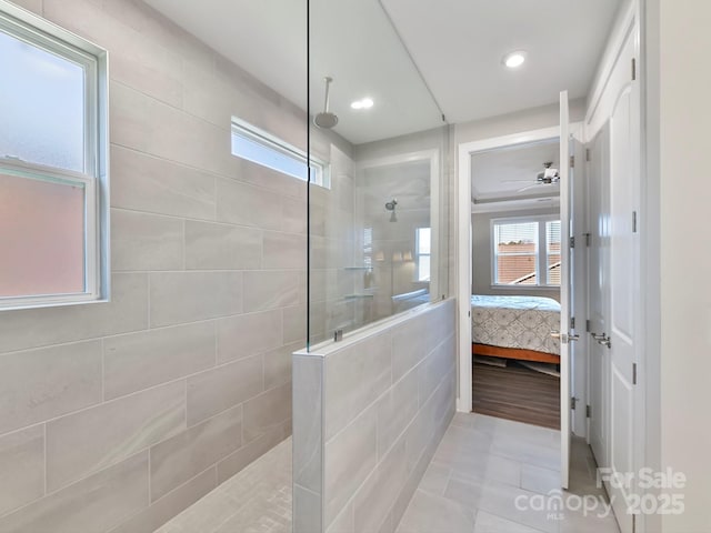 bathroom with tiled shower, tile patterned floors, and ceiling fan