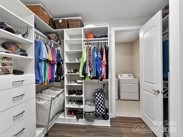 spacious closet with washer / clothes dryer and dark tile patterned floors