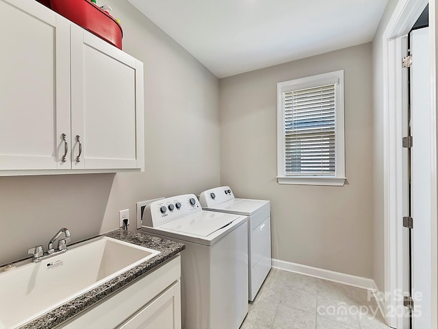 laundry room featuring sink, separate washer and dryer, and cabinets