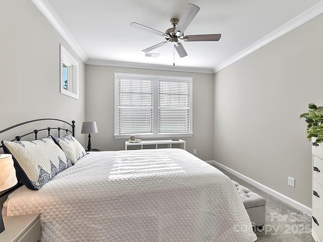 carpeted bedroom with ceiling fan and ornamental molding