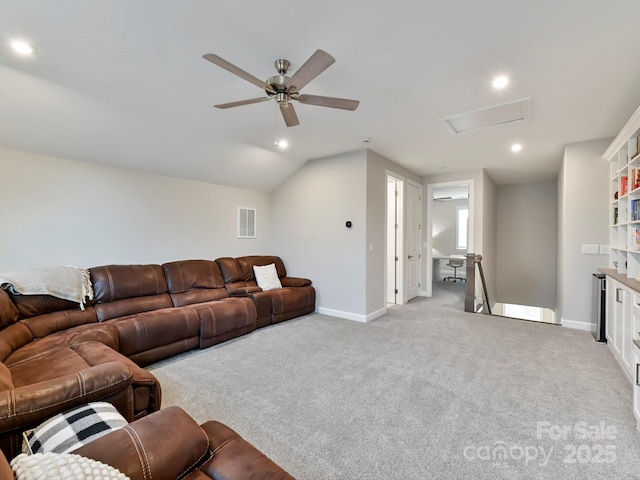 living room featuring ceiling fan, vaulted ceiling, and light colored carpet