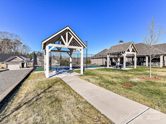 surrounding community with a lawn, a gazebo, and tennis court