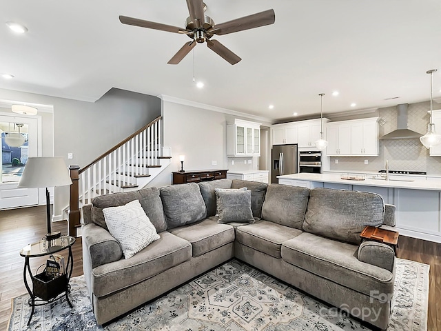 living room with sink, hardwood / wood-style floors, ceiling fan, and crown molding