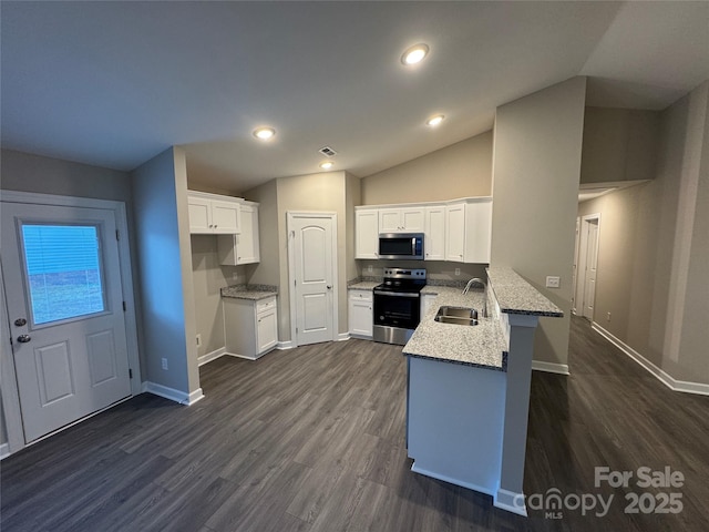 kitchen featuring white cabinetry, sink, kitchen peninsula, lofted ceiling, and appliances with stainless steel finishes