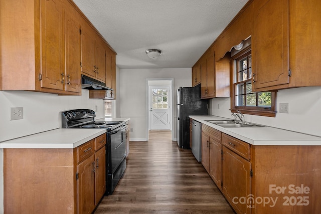 kitchen with a textured ceiling, sink, a healthy amount of sunlight, and black appliances