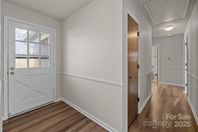 doorway featuring dark hardwood / wood-style floors and a textured ceiling