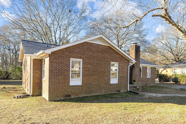 view of side of home with a yard