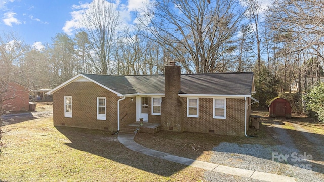 view of front of property with a storage shed