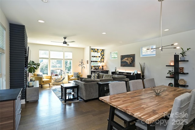 dining space with dark wood-type flooring and ceiling fan