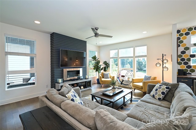 living room with ceiling fan and wood-type flooring