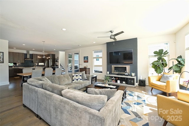 living room with ceiling fan and light hardwood / wood-style floors