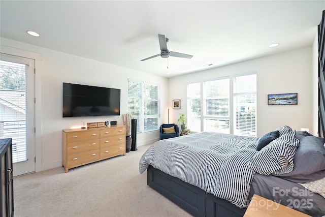 carpeted bedroom with ceiling fan and access to exterior