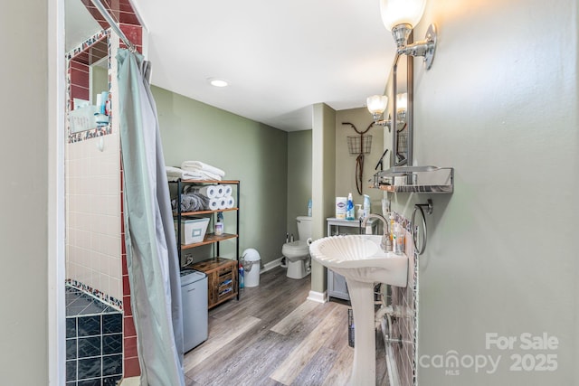 bathroom with toilet and hardwood / wood-style floors