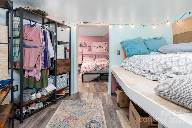 bedroom with dark wood-type flooring