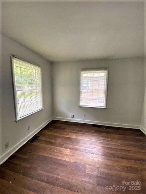 empty room featuring dark wood-type flooring