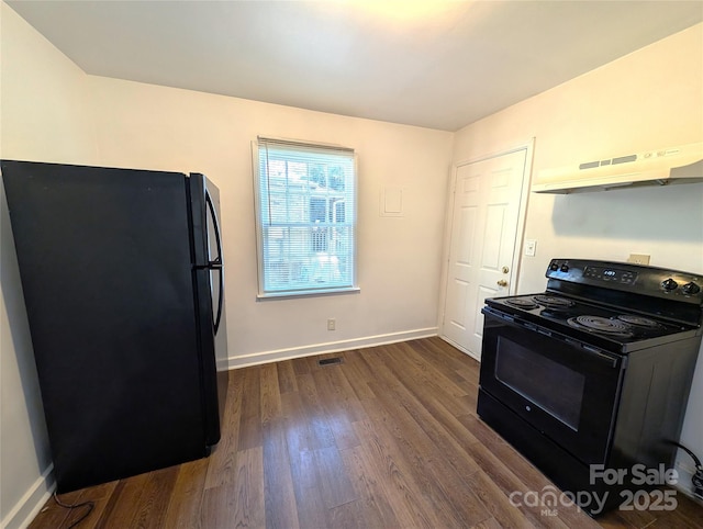 kitchen featuring black appliances and dark hardwood / wood-style flooring