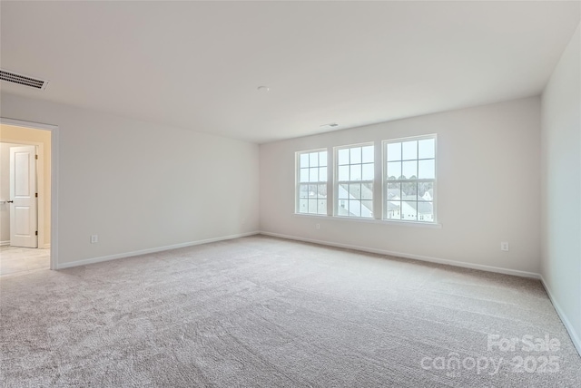 unfurnished room with light carpet