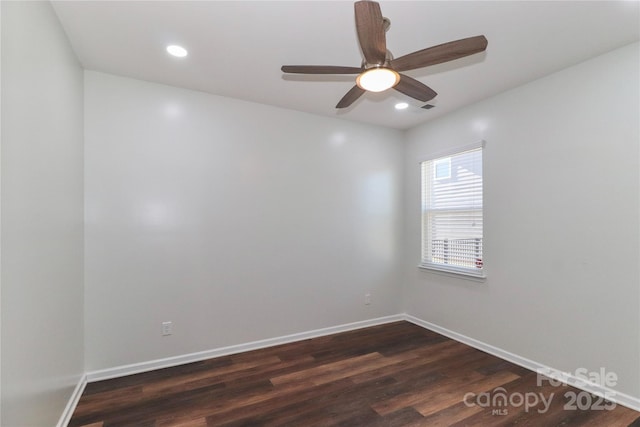 empty room featuring ceiling fan and dark hardwood / wood-style flooring