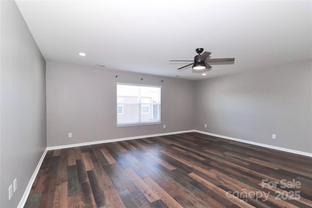 spare room featuring ceiling fan and dark wood-type flooring